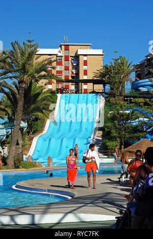 Water slide and pool in the water park with tourists enjoying the setting, Fuengirola, Malaga Province, Andalusia, Spain, Western Europe. Stock Photo