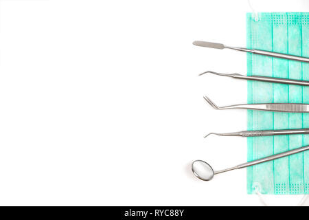 Dentist's tools and mask on white background. Stock Photo