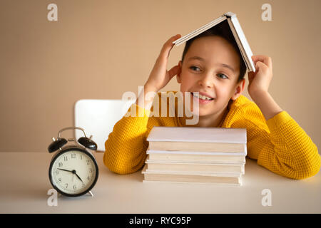 Thinking child bored, frustrated and fed up doing his homework Stock Photo