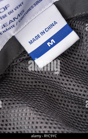 Made in China clothing label stitched into garment. For Chinese export-imports, US-China tariffs, Chinese textiles, offshoring to China, foreign trade Stock Photo