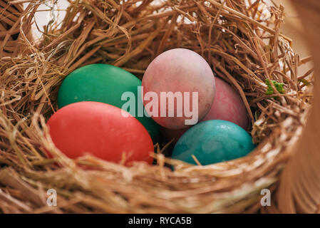 Beautiful Easter composition with multicolored eggs and flowers on linen background Stock Photo