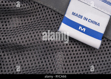 Made in China clothing label stitched into garment. For Chinese export-imports, US-China tariffs, Chinese textiles, offshoring to China, foreign trade Stock Photo