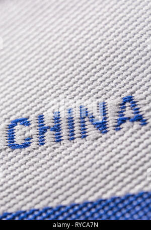 Made in China clothing label stitched into garment. For Chinese export-imports, US-China tariffs, Chinese textiles, offshoring to China, foreign trade Stock Photo