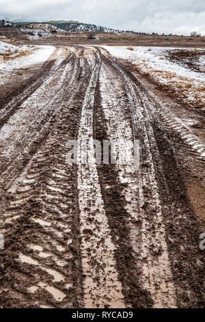 Muddy tire tracks on a ranch dirt road; central Colorado; USA Stock Photo