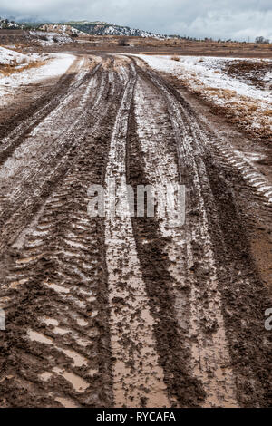 Muddy tire tracks on a ranch dirt road; central Colorado; USA Stock Photo