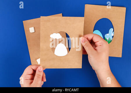 Diy Easter cards from paper. Volume greeting cards with a bunny, egg on blue background. 3d. Gift idea, decor Spring, Easter. Step by step. Top view.  Stock Photo
