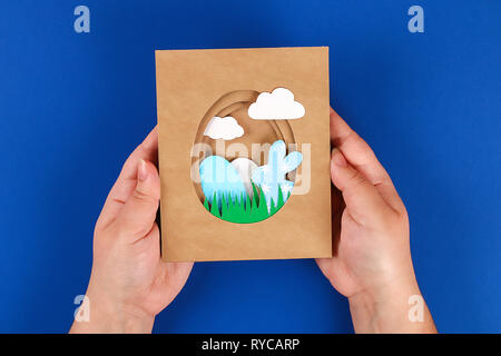 Diy Easter cards from paper. Volume greeting cards with a bunny, egg on blue background. 3d. Gift idea, decor Spring, Easter. Step by step. Top view.  Stock Photo
