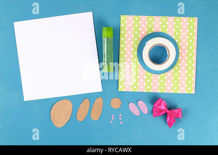 Diy Easter cards from paper. Volume greeting cards with a bunny, egg on blue background. 3d. Gift idea, decor Spring, Easter. Step by step. Top view.  Stock Photo
