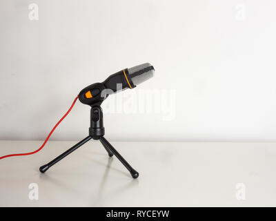 Microphone on a white table. Recording and broadcast concepts. Stock Photo