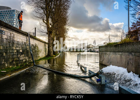 An SNCF agent monitors the pumping of the water that floods the RER C rail track at the Javel station due to the winter flood of the Seine in Paris. Stock Photo