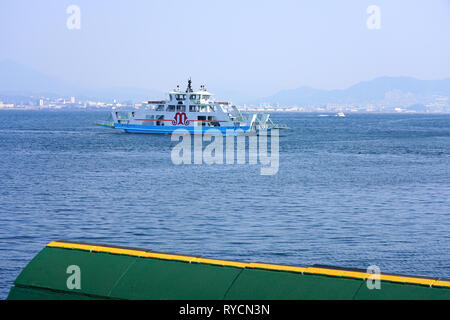 MIYAJIMA, JAPAN -26 FEB 2019- View of a ferry transporting visitors to the Japanese island of Itsukushima (Miyajima) in the Hiroshima Bay, Japan. Stock Photo