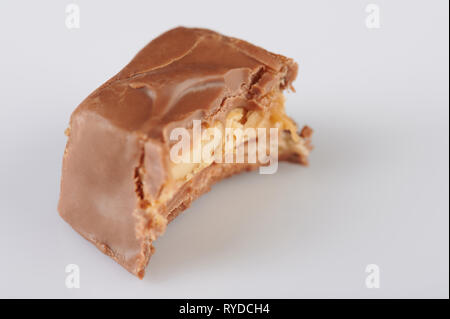 Piece of chocolate candy bar bite isolated on white background Stock Photo
