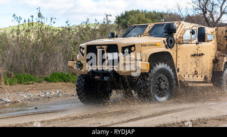 A Joint Light Tactical Vehicle displays its overall capabilities during a live demonstration at the School of Infantry West, Marine Corps Base Camp Pendleton, California, Feb. 27, 2019. The JLTV consists of multiple platforms capable of completing a variety of missions while providing increased protection and mobility for personnel across the Marine Corps. (Official Marine Corps photo by Sgt. Timothy R. Smithers/Released) Stock Photo