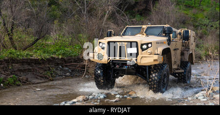 A Joint Light Tactical Vehicle displays its overall capabilities during a live demonstration at the School of Infantry West, Marine Corps Base Camp Pendleton, California, Feb. 27, 2019. The JLTV consists of multiple platforms capable of completing a variety of missions while providing increased protection and mobility for personnel across the Marine Corps. (Official Marine Corps photo by Sgt. Timothy R. Smithers/Released) Stock Photo