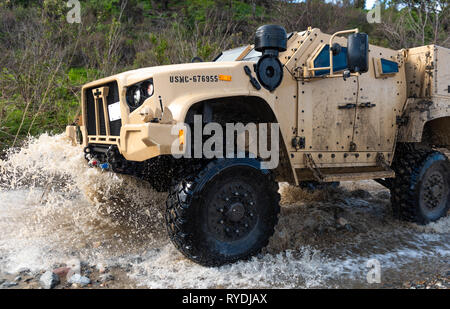 A Joint Light Tactical Vehicle displays its overall capabilities during a live demonstration at the School of Infantry West, Marine Corps Base Camp Pendleton, California, Feb. 27, 2019. The JLTV consists of multiple platforms capable of completing a variety of missions while providing increased protection and mobility for personnel across the Marine Corps. (Official Marine Corps video by Sgt. Timothy R. Smithers/Released) Stock Photo