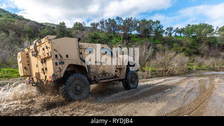 A Joint Light Tactical Vehicle displays its overall capabilities during a live demonstration at the School of Infantry West, Marine Corps Base Camp Pendleton, California, Feb. 27, 2019. The JLTV consists of multiple platforms capable of completing a variety of missions while providing increased protection and mobility for personnel across the Marine Corps. (Official Marine Corps photo by Sgt. Timothy R. Smithers/Released) Stock Photo