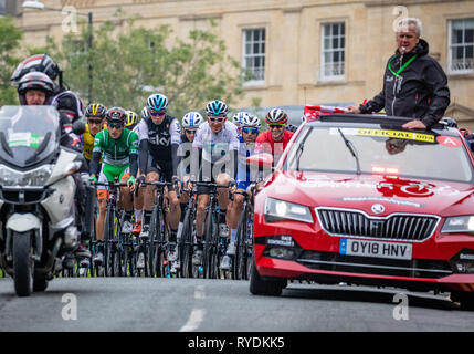 Official marshall car and peleton in the OVO Energy Tour of Britain bike race stage 3 as it passes through Clifton in Brstol UK on September 4th 2018 Stock Photo