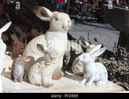 Funny easter decoration . White rabbit family, mother plus young rabnbits with funny faces, burned in gypsum. Stock Photo