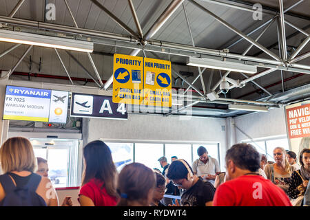 Ciampino, Italy - September 6, 2018: People passengers waiting to board delayed Ryanair airplane domestic European Union flight low-cost cheap airline Stock Photo