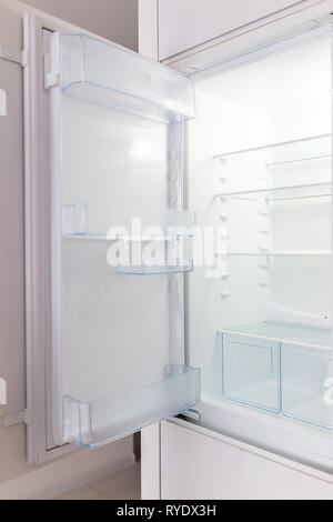 Open empty modern white kitchen refrigerator fridge inside interior vertical closeup of appliance Stock Photo