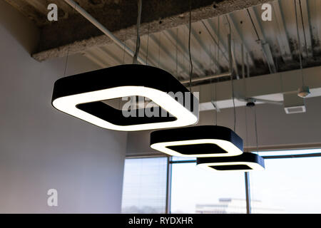 New modern office room in building with corporate business ceiling closeup of row of many square contemporary lights Stock Photo