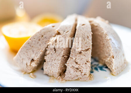 Macro closeup of large vegan nut almond cheese slices with white texture and large pieces cut sliced Stock Photo