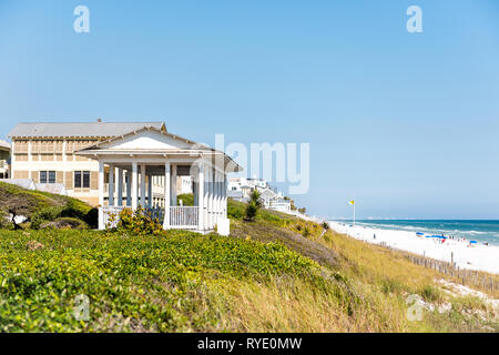 Seaside, USA - April 25, 2018: Wooden pavilions by beach ocean with coastline gazebo in Florida architecture andview during sunny day Stock Photo