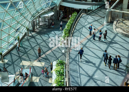 Overhead view of the various light filled galleries of a shopping mall in central Warsaw, Poland on a bright sunny afternoon Stock Photo