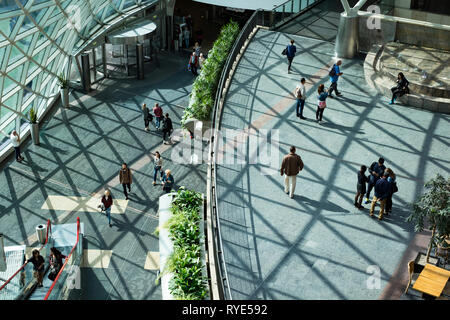 Overhead view of the various light filled galleries of a shopping mall in central Warsaw, Poland on a bright sunny afternoon Stock Photo