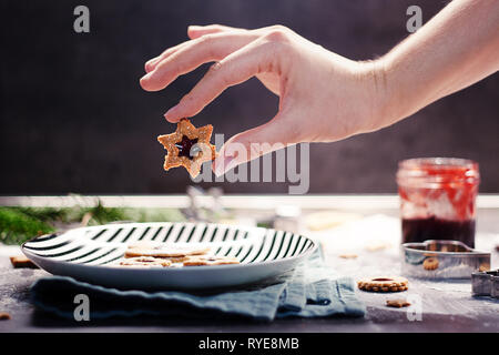 Hand holding homemade baked christmas sugar cookies Stock Photo
