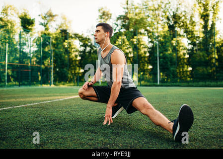 Man doing stretching exercise on outdoor workout Stock Photo