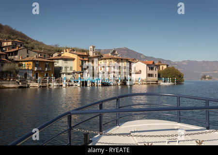 Ferryboat approaching Carzano on Monte Isola, Lombardy, Italy Stock Photo