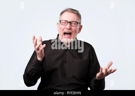 Angry shocked man screaming, isolated on white background. Stock Photo