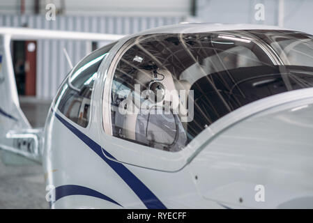 Small propeller plane in hangar, private airline Stock Photo