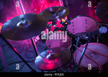 Rock music background with drum set in purple stage lights, close-up photo, soft selective focus Stock Photo