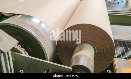 A thin sheet of paper on the roll in Rapina Estonia rolling around making a thick roll Stock Photo