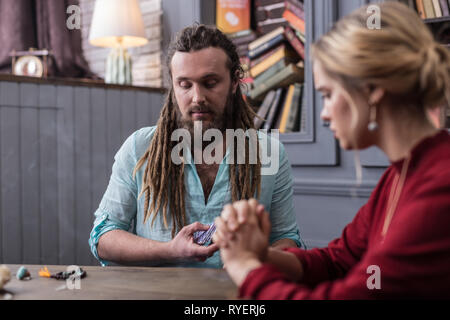 Nice serious fortune teller looking at the cards Stock Photo