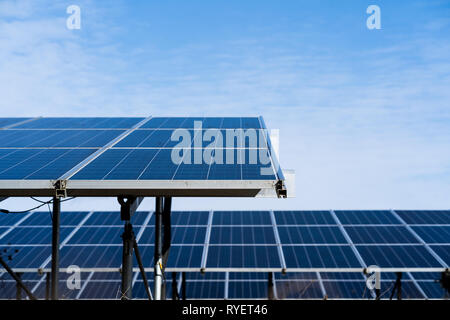Solar cells in a row, blue sky background. Photovoltaic supply Stock Photo