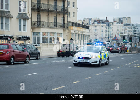 Police car responding to emergency call on King's Road, Brighton in Sussex, England. Stock Photo