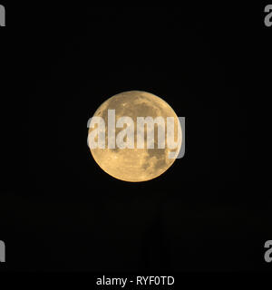 Full Moon named Cold Moon rising on black background, square crop. Stock Photo