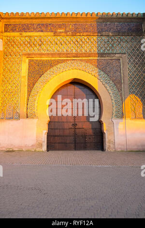 Golden hour at centered Bab al mansour gate in the old town medina of Meknes, Morocco. Vertical Stock Photo