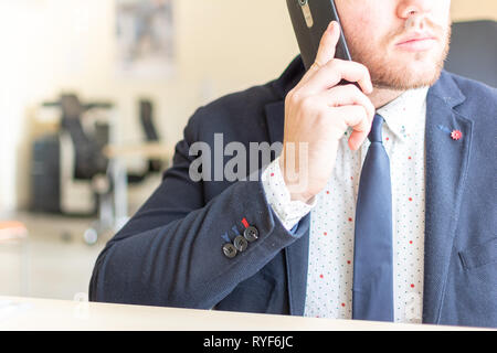 Man sitting while using the mobile smartphone. Confident Entrepreneur working on phone Stock Photo