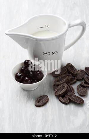 Black forest gateau ingredients; cream, cherries, chocolate Stock Photo