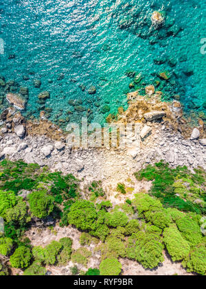Recent drone aerial photo of the Mediterranean ocean meeting the rocky coast of Corfu in Greece Stock Photo