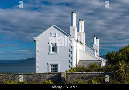 Whitewashed Coastguard Cottages at Trwyn Du Penmon Anglesey off North Wales on a sunny September afternoon. These are now used as holiday homes. Stock Photo