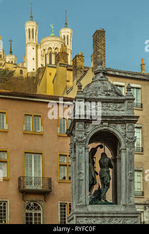 Old Lyon, the baptismal fountain in Place Saint-Jean and the basilica of fourviere. Lyon Stock Photo