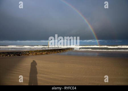 Island Wangerooge, Ostfriesland, rainbow at over the beach, during a winter storm,East Frisia, Northern Germany, North Sea Coast, Stock Photo