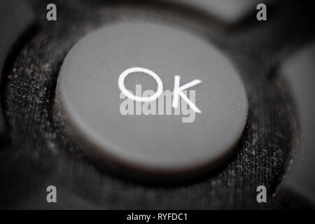 Close-up of an OK button on a domestic TV remote control. Stock Photo
