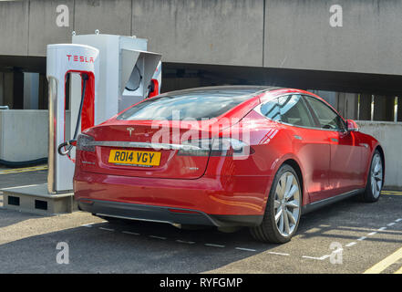 Tesla Model S electric car charging at a Supercharger station Stock Photo