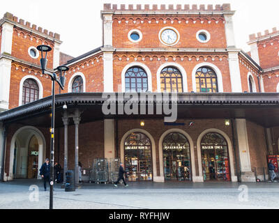 BRESCIA, ITALY - FEBRUARY 21, 2019: people in front of train station in Brescia city in evening. Brescia is the second largest city in Lombardy Stock Photo